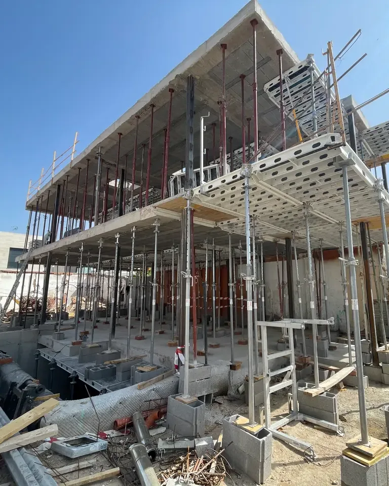 Estructura de una vivienda en obra con los forjados apuntalados y andamios